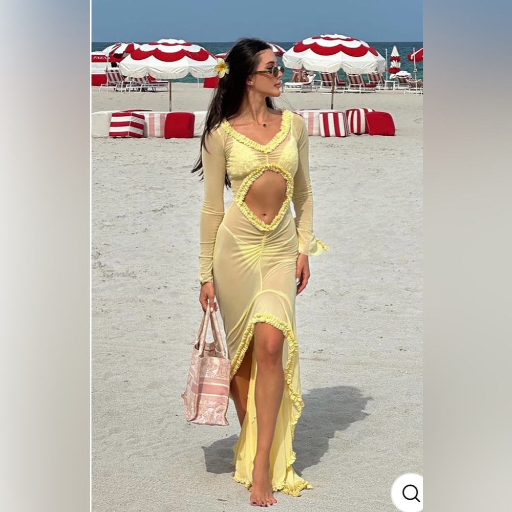 Yellow mesh maxi dress with ruffles around the cuffs of the wrist.